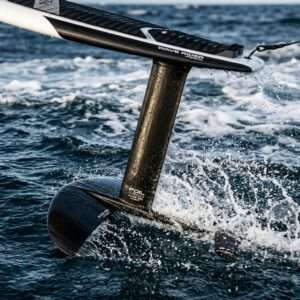 A modern carbon hydrofoil wing cutting through deep blue ocean water